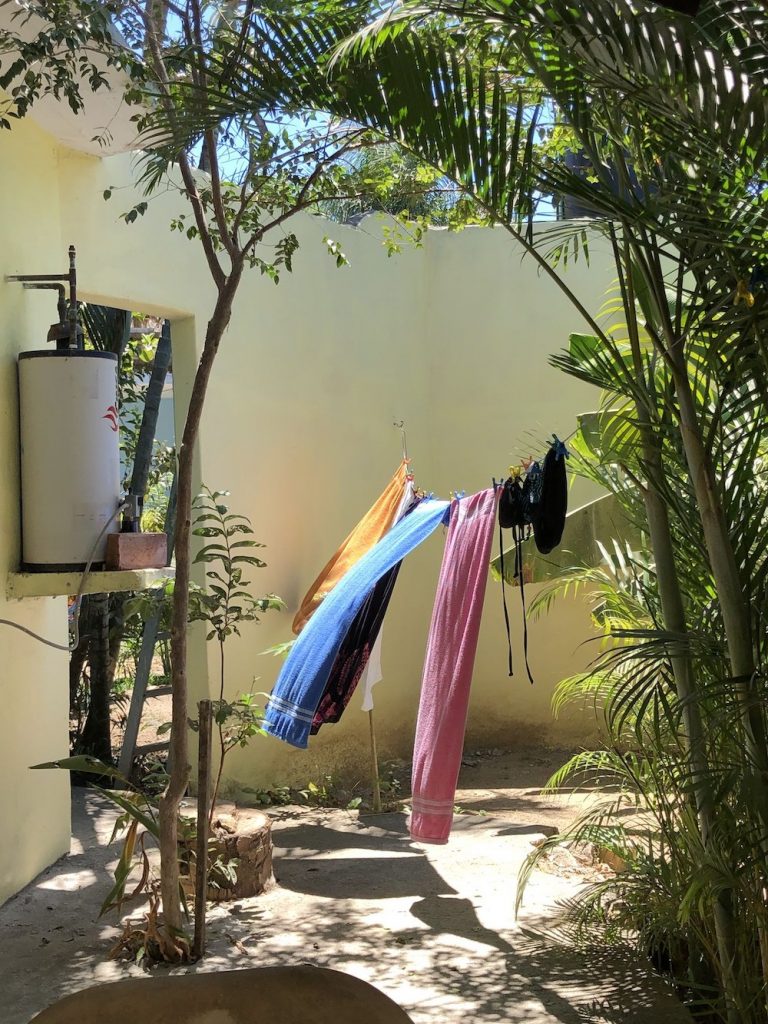 Beach towels on the clothesline:  I figured you might ask for a reference photo so here it is. It's one of a number I took before I began painting en plein air. You can see the light hasn't begun to hit the wall yet.