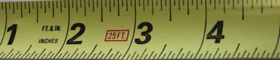 Inches are written in fractions: Tape measure with inches showing sixteenths